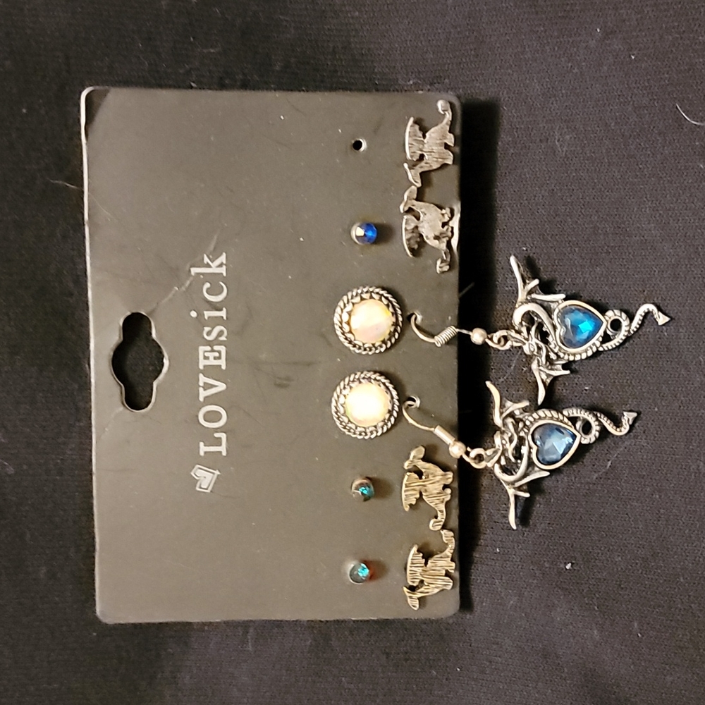 6 pairs of earrings, 1 blue earring missing.